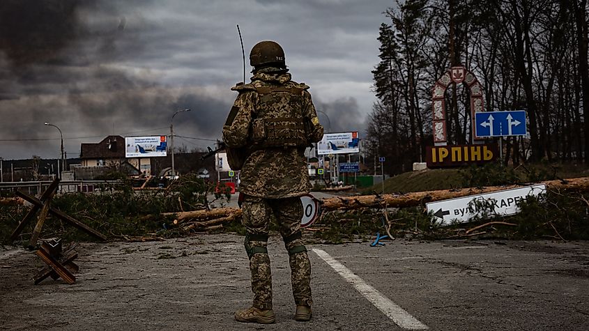 A Ukrainian soldier stands guard on the outskirts of Kyiv. March 5th, 2022. Credit Shutterstock: Kutsenko Volodymyr.