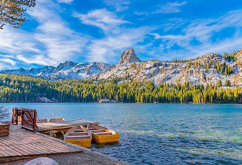 Boats sit at dock at Lake George under the watchful eye of the Crystal Crag peak. This peak is in Mammoth Lakes in Central California, in Sierra Nevada Mountains