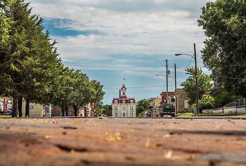 Horizontal photo of the old downtown area of Cottonwood Falls, KS with the courthouse at the end of the street (all logos edited out)