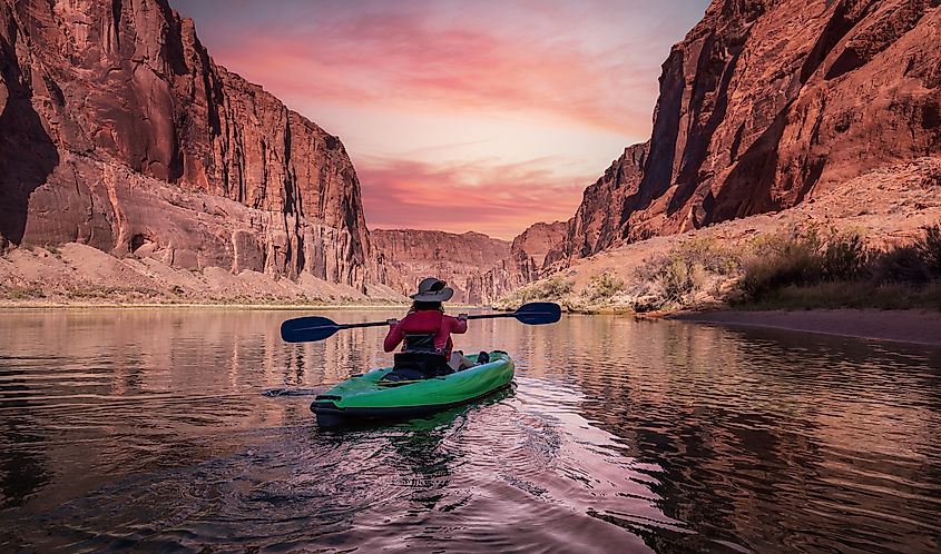 A woman kayaker in the Glen Canyon, Arizona.