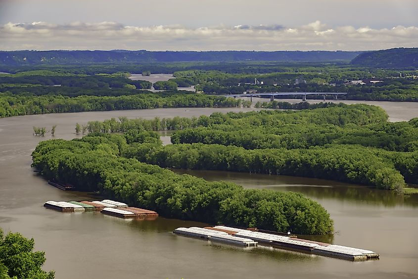 Loaded barges traverse the Mississippi River near McGregor, Iowa.