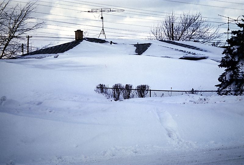 Photo of a house almost completely buried in snow in the aftermath of the "Blizzard of '77" in Western New York.