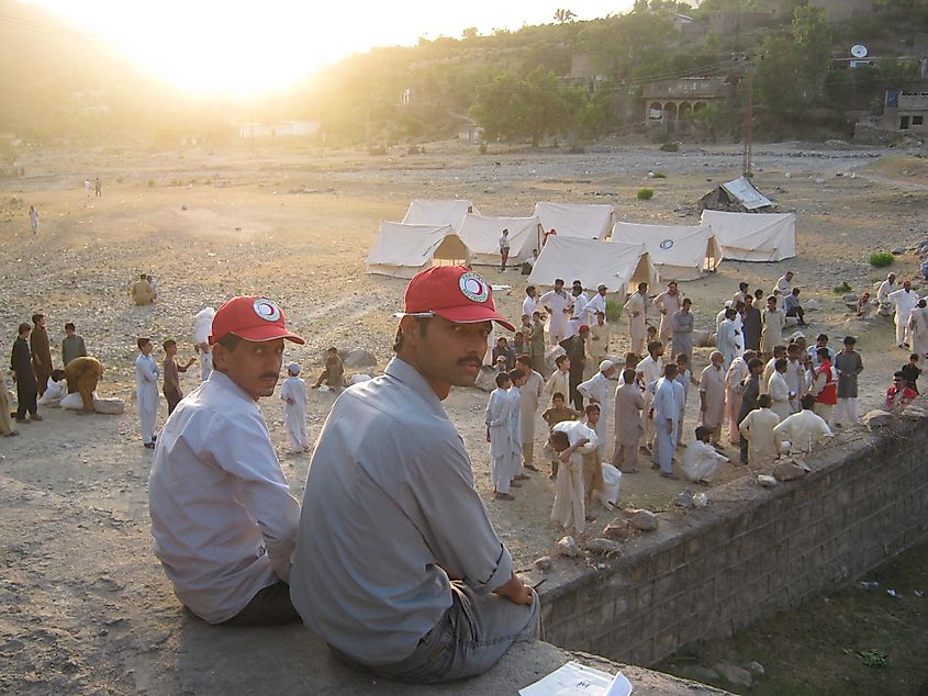  Volunteers of the Red Crescent sitting in front of a camp city established after the earthquake.