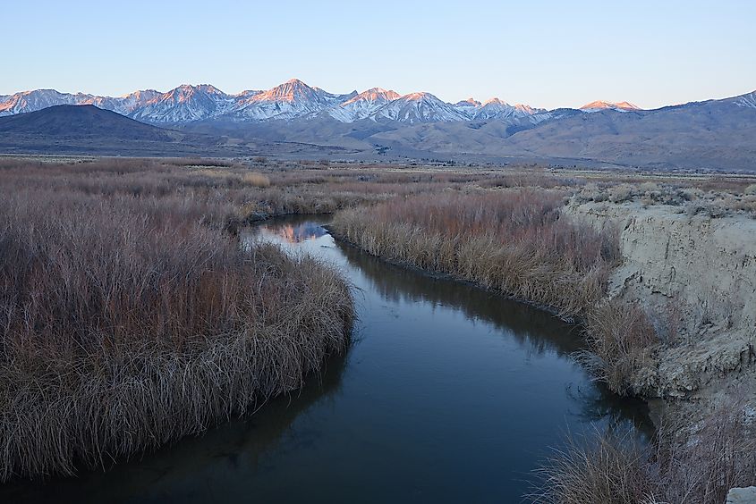 River bend with mountain peaks of sierra nevada mountain range near Big Pine, California