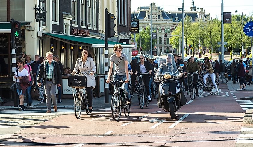 People riding bicycles in historical part of Amsterdam in a beautiful summer day,