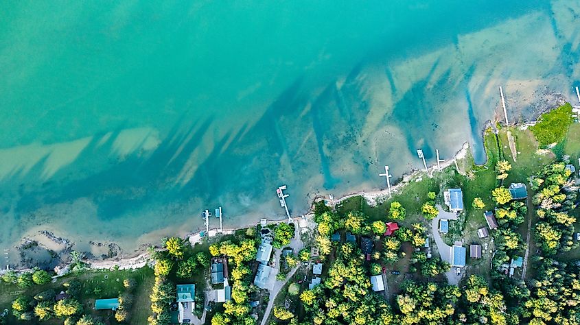 Aerial drone view of lake houses and docks on St. Mary's River, situated between Lake Superior and Lake Huron