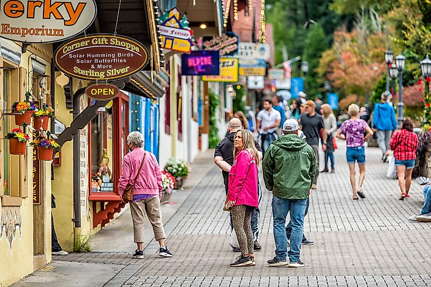 The Bavarian-themed village of Helen, Georgia, is bustling with tourists exploring its traditional alpine architecture along Main Street.