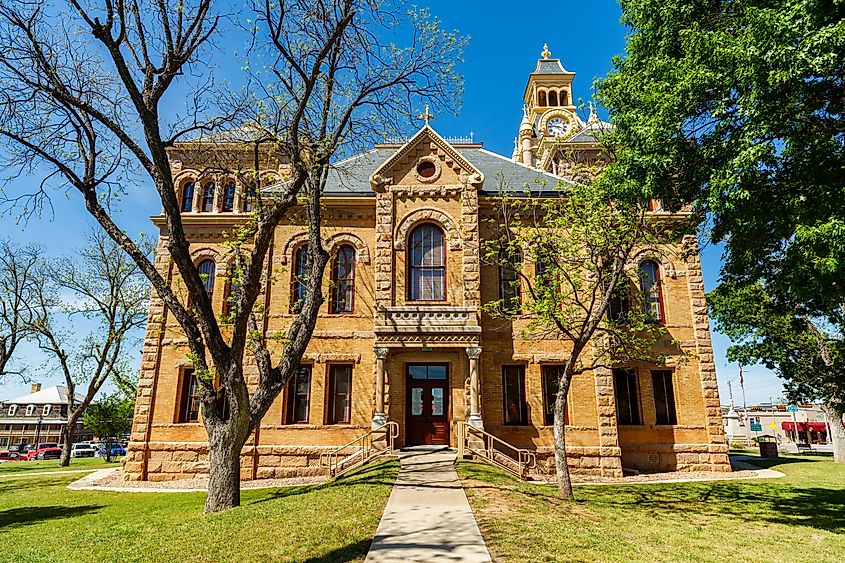 The historic Llano Courthouse in Llano, Texas, situated in the scenic Hill Country, featuring its classic stone architecture and central clock tower.