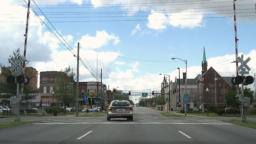 A view down Main Street, looking past the railroad tracks, with shops and buildings lining the street, in Carbondale, Illinois.