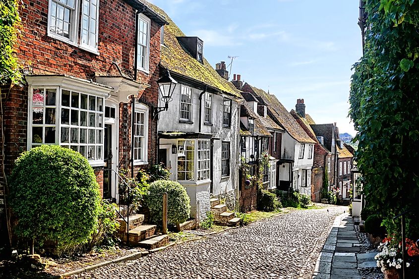 Cobblestone lane lined with medieval buildings in the old town of Rye, East Sussex, England.
