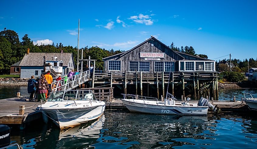 Tourists walk up the dock ramp at Islesford, Maine.