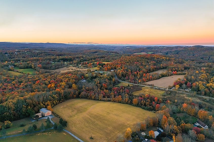 Wantage NJ farmlands at dusk in Autumn with High Point State Park Monument on Kittatinny Mountains.