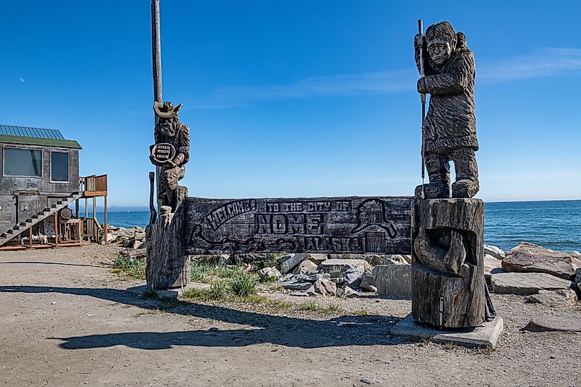 The wooden carved monument depicting a gold panner and native Alaskan on the shore of the Bering Sea in Nome, Alaska.