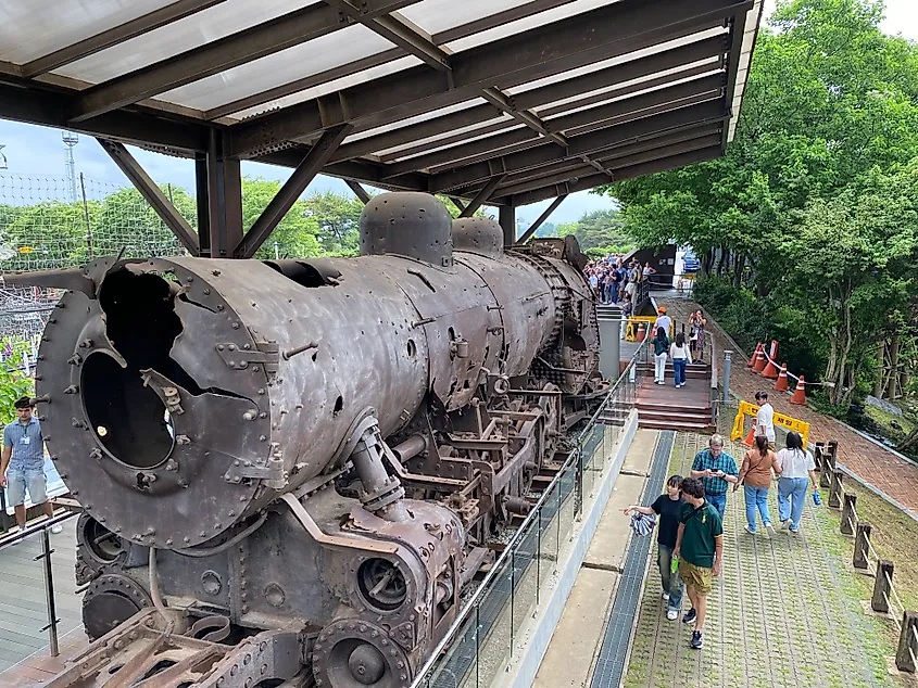 A rusty and dilapidated steam engine on display.