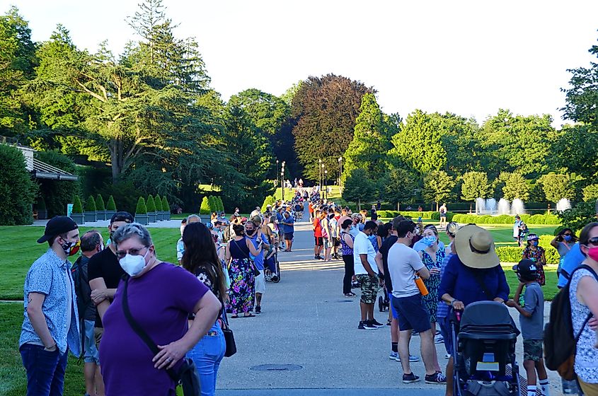 Large crowds wearing masks waiting in a long line to see the Titan Arum, the infamous corpse flower, in Kennett Square, Pennsylvania.