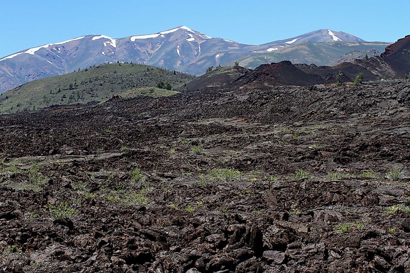 Black lava flows and cinder cones across Craters of the Moon in south-central Idaho.