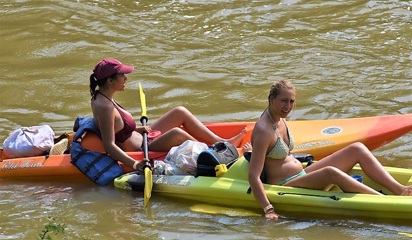 Two young woman kayaking on the Miami River in Milford Ohio