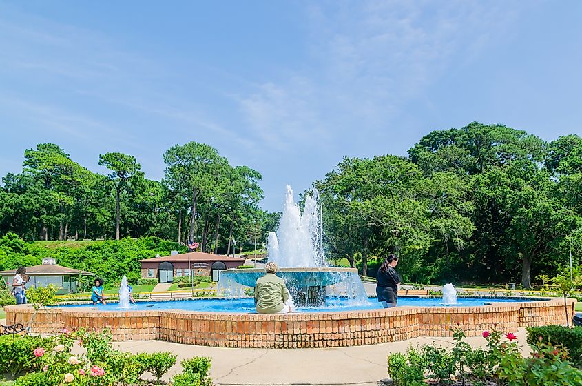 People sitting by the fountain at the Fairhope Municipal Pier in Fairhope, Alabama.
