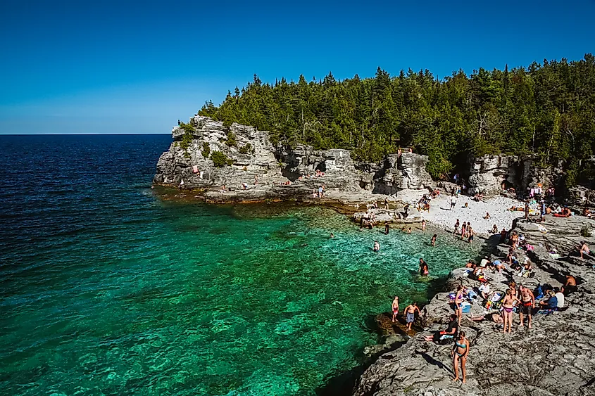 Forested limestone cliffs and the clear water of Georgian Bay at Bruce Peninsula National Park.