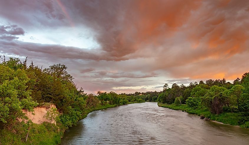 Colorful sunrise clouds over the Niobrara River near Valentine, Nebraska, USA