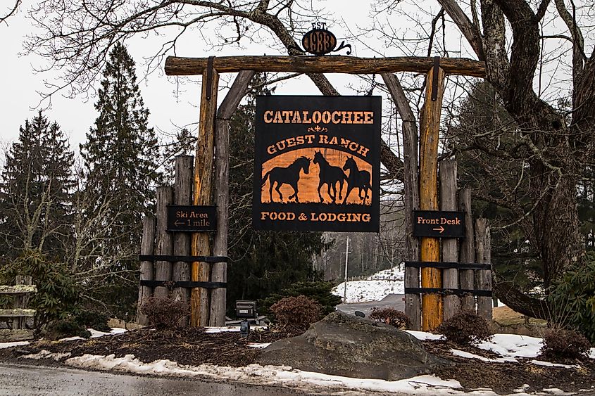 Maggie Valley, North Carolina, USA: A wooden sign for Cataloochee Guest Ranch against a snowy background.