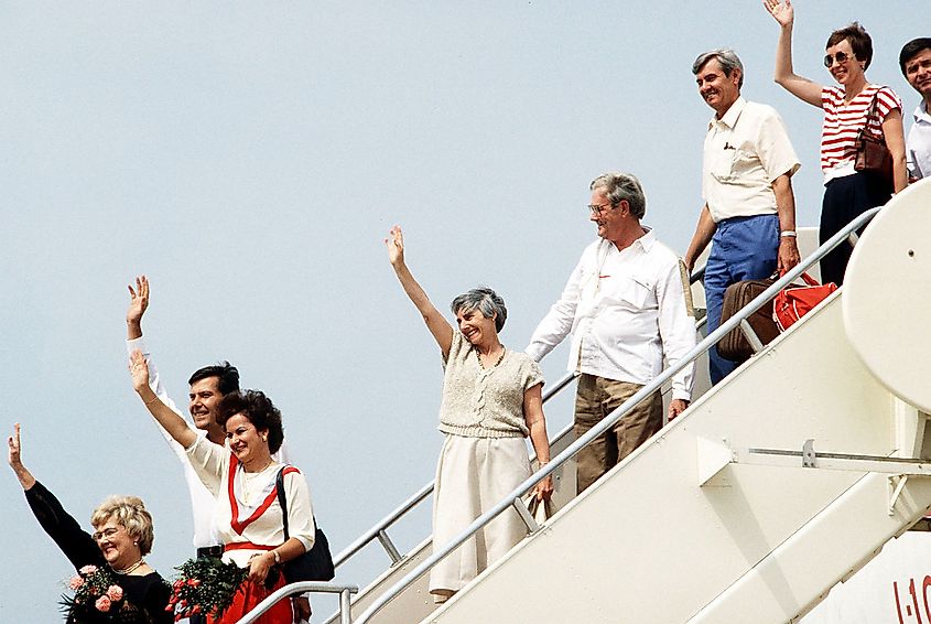 Former TWA hostages wave to family and friends upon their arrival back in the US.