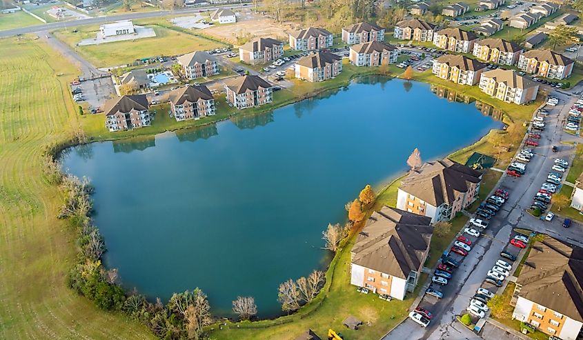 Aerial autumn scene the Denham Springs small town apartment complex near pond in Louisiana US