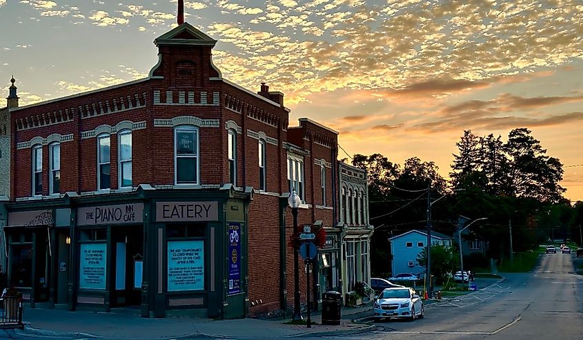 Historic corner building with impressive facade at sunset with small clouds in Port Perry, Ontario.