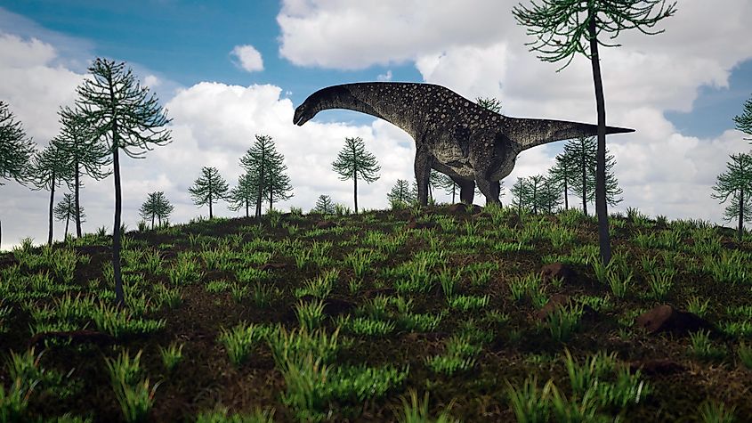 3d render of a titanosaur walking through thick foliage.