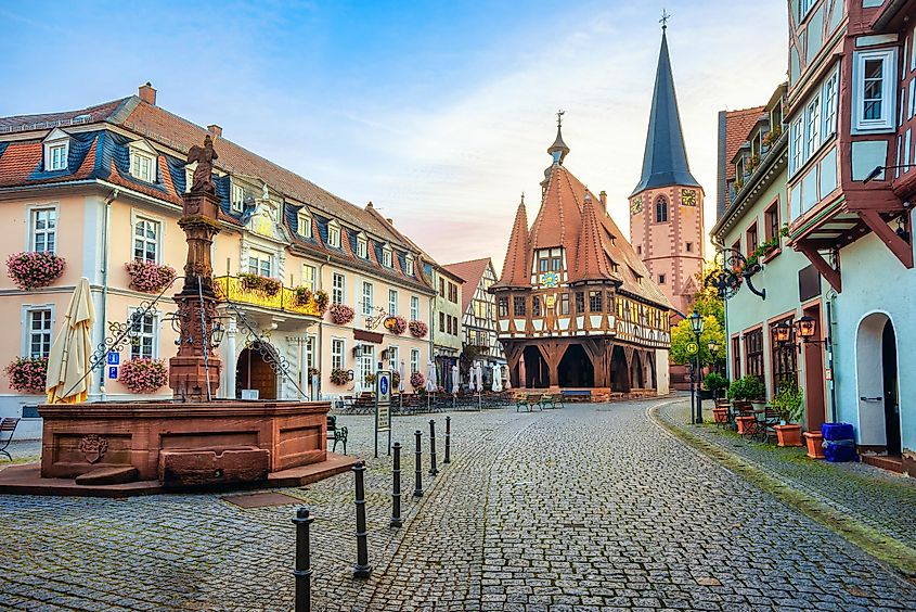 Historical Old Town of Michelstadt in Odenwald, Germany, featuring colorful houses and the timber-frame Town Hall on the central square at sunrise.