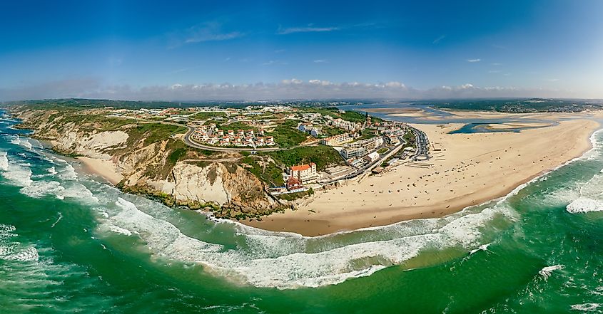 Hotels and homes on the seaside cliffs of Foz do Arelho, with the lagoon in the background and the town center further inland.