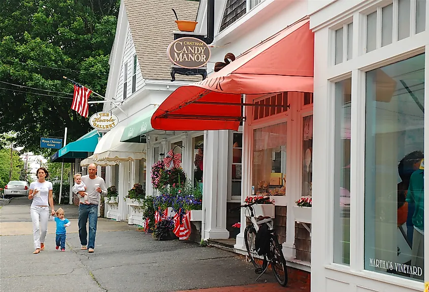A young family walks through the town of Chatham, Massachusetts.