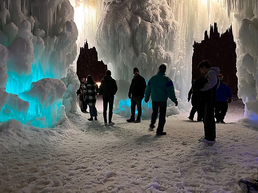 Visitors gathered around the illuminated Ice Castles in Midway, Utah