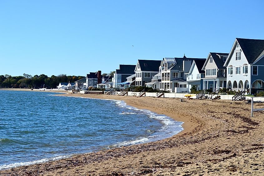 Beachfront homes with sand and waves in Madison, Connecticut.