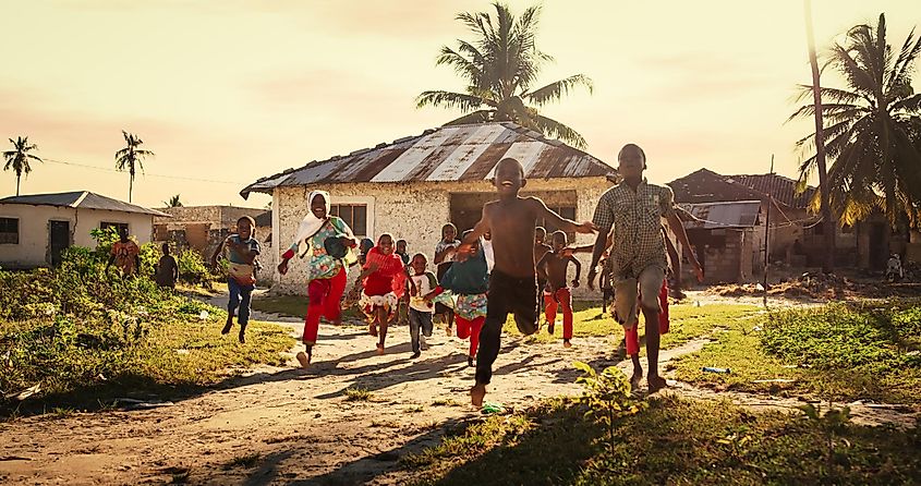 Children in a tropical community laughing and playing together.