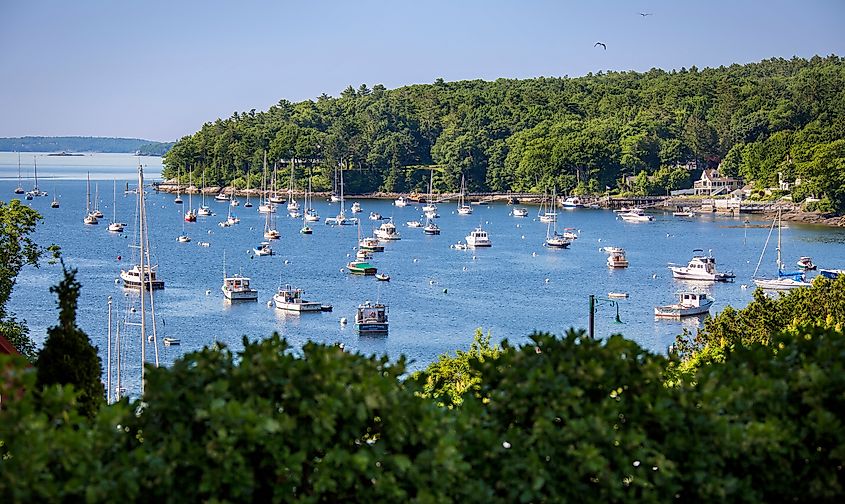 Sailboats and motorboats anchored in Rockport Harbor, Maine, on a beautiful summer day.