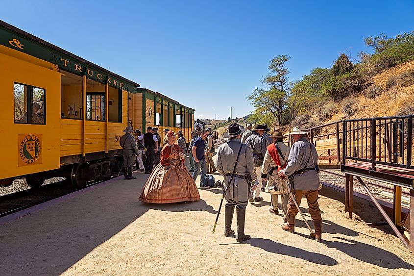 Passengers in period costumes prepare to board a steam locomotive in Virginia City, Nevada.