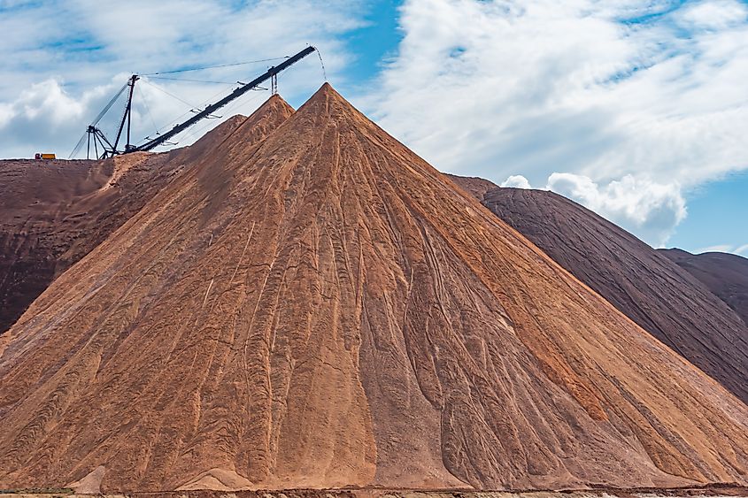 Close-up of the potash mining industry in Soligorsk, Belarus: Telestacker handling ore for potash waste heaps and fertilizer extraction in a quarry.