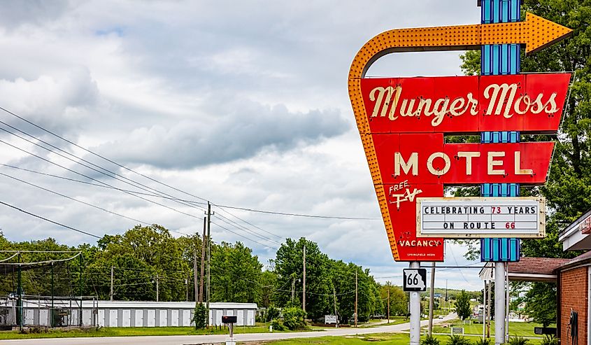 Route 66 motel entrance sign. Munger Moss Motel vintage red sign, cloudy spring day in Lebanon Missouri