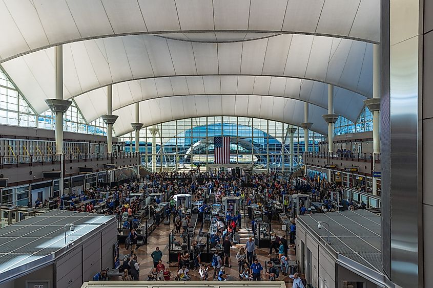 Travelers in long lines at Denver International Airport waiting to go through security screening.