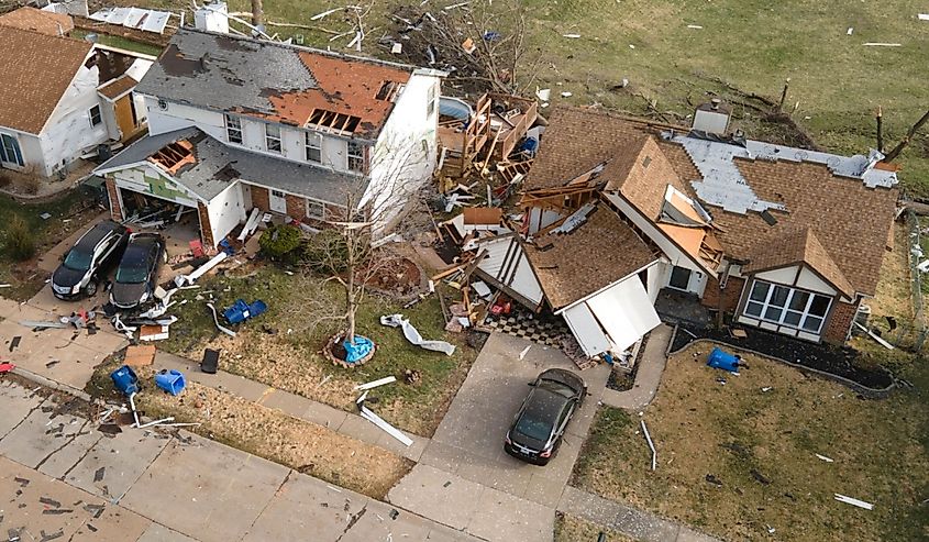 Debris surrounds damaged homes after a tornado struck Florissant, Missouri