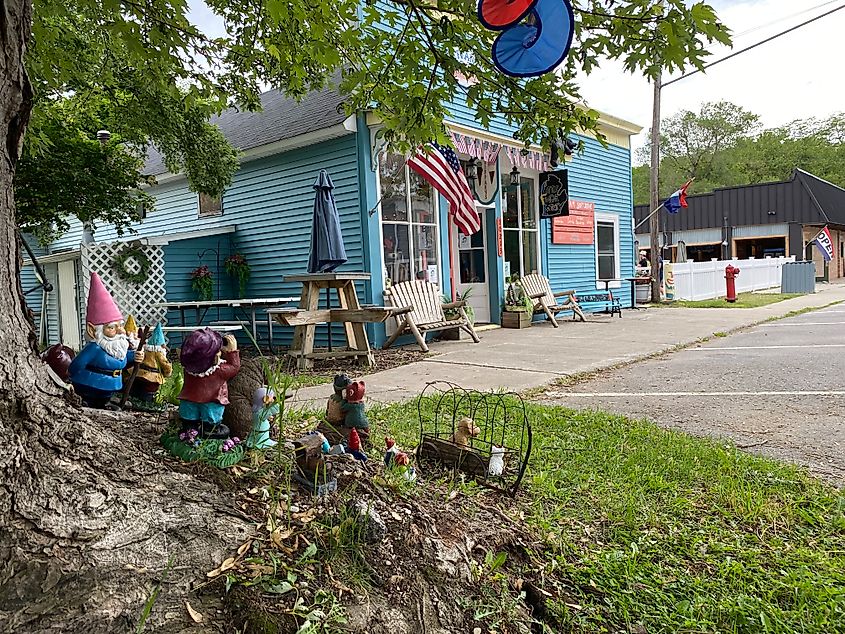 Decorative garden gnomes placed at the base of a tree before an indie ice cream parlor in Empire, Michigan.  