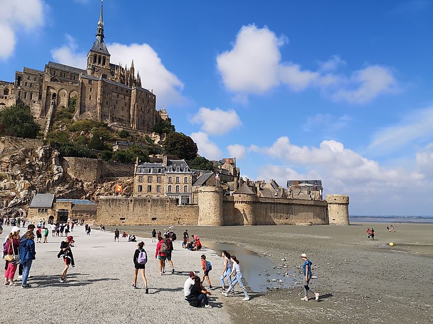 People next to Mont-Saint-Michel in France.