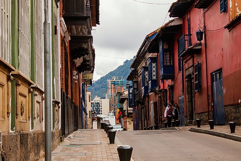 Streets of La Candelaria neighborhood with colonial-era buildings in Bogotá, Colombia. Image Credit Gabriel Leonardo Guerrero via Shutterstock.