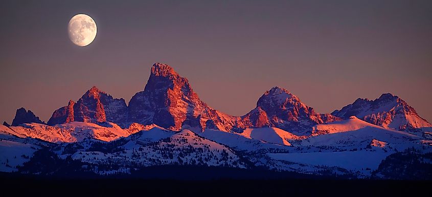  Alpen glow on Tetons Tetons mountains rugged with moon rising on Idaho side