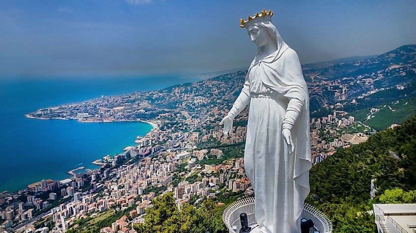 A scenic view of the Lebanese coastline from Harissa, with the iconic church of Our Lady of Lebanon perched on the hilltop.