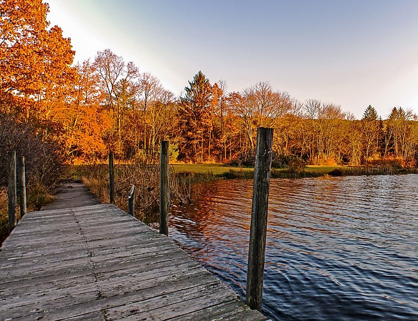 An autumn view from the dock at Lake Ashroe at Stokes State Forest in Branchville, New Jersey.