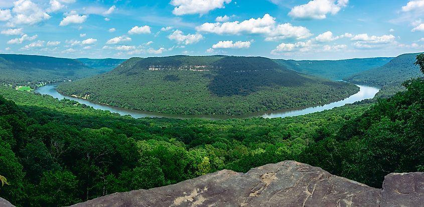 A panoramic view of the Tennessee River winding through a lush valley, captured from Snoopers Rock in Prentice Cooper State Forest. 