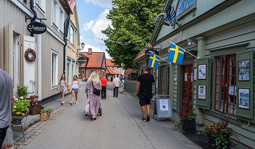 Tourists on central walking street of the city of Sigtuna. 