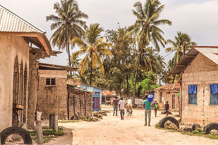 Daily life of local people taking place along road on Zanzibar Island in Tanzania.